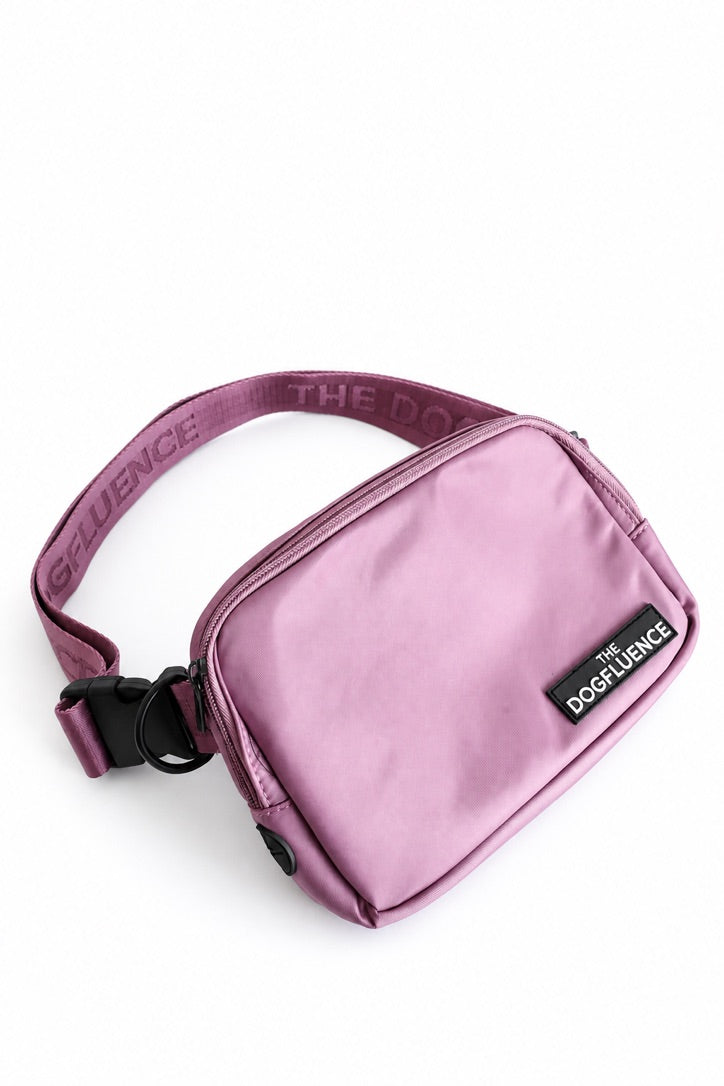 The Mini Pouch in Cake, a soft pink, front view with its adjustable strap and quick-release buckle