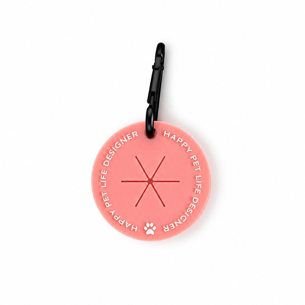 The Poop Bag Holder in Coral, a clip-on silicone case for a used poo bag